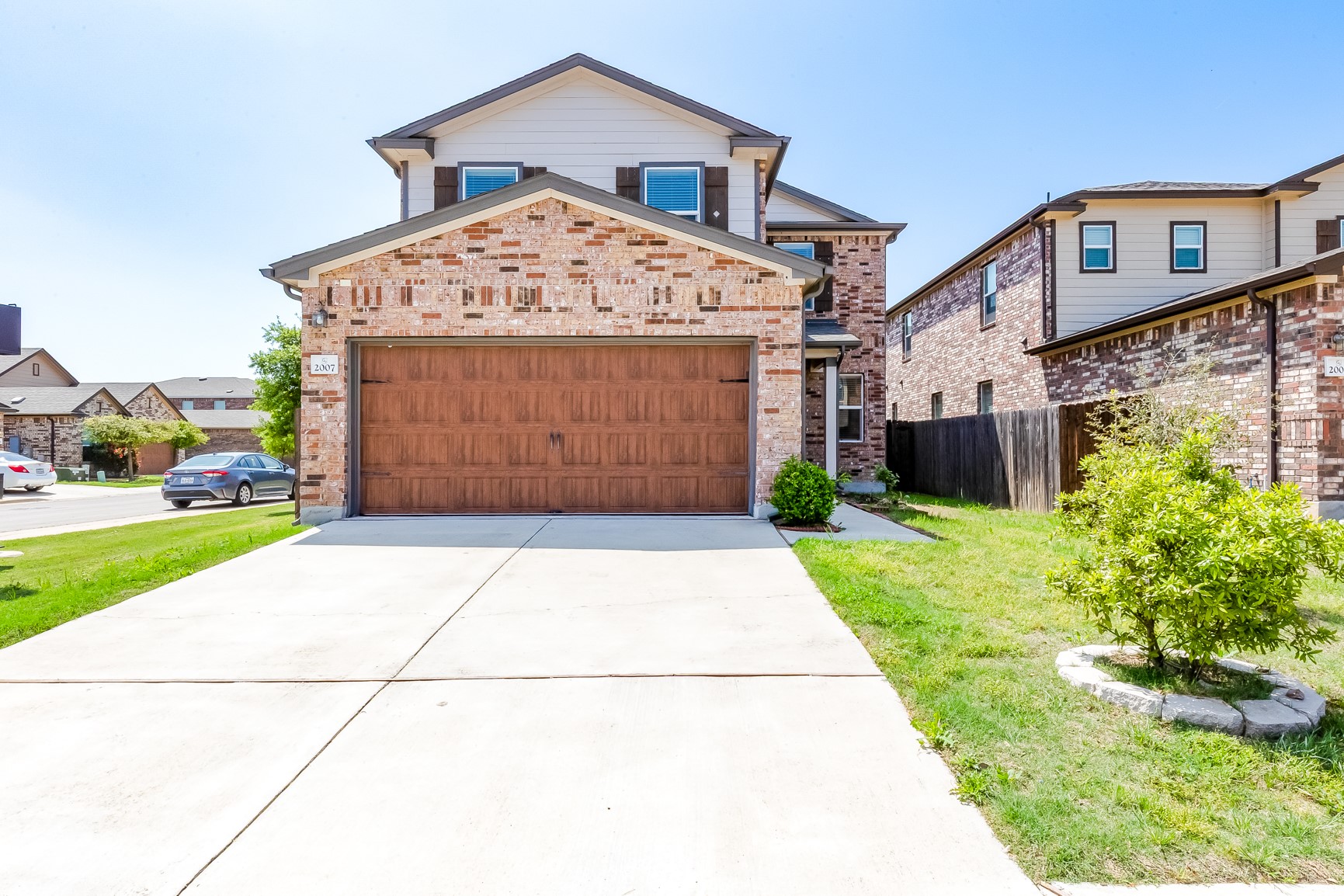 a front view of a house with a yard and garage