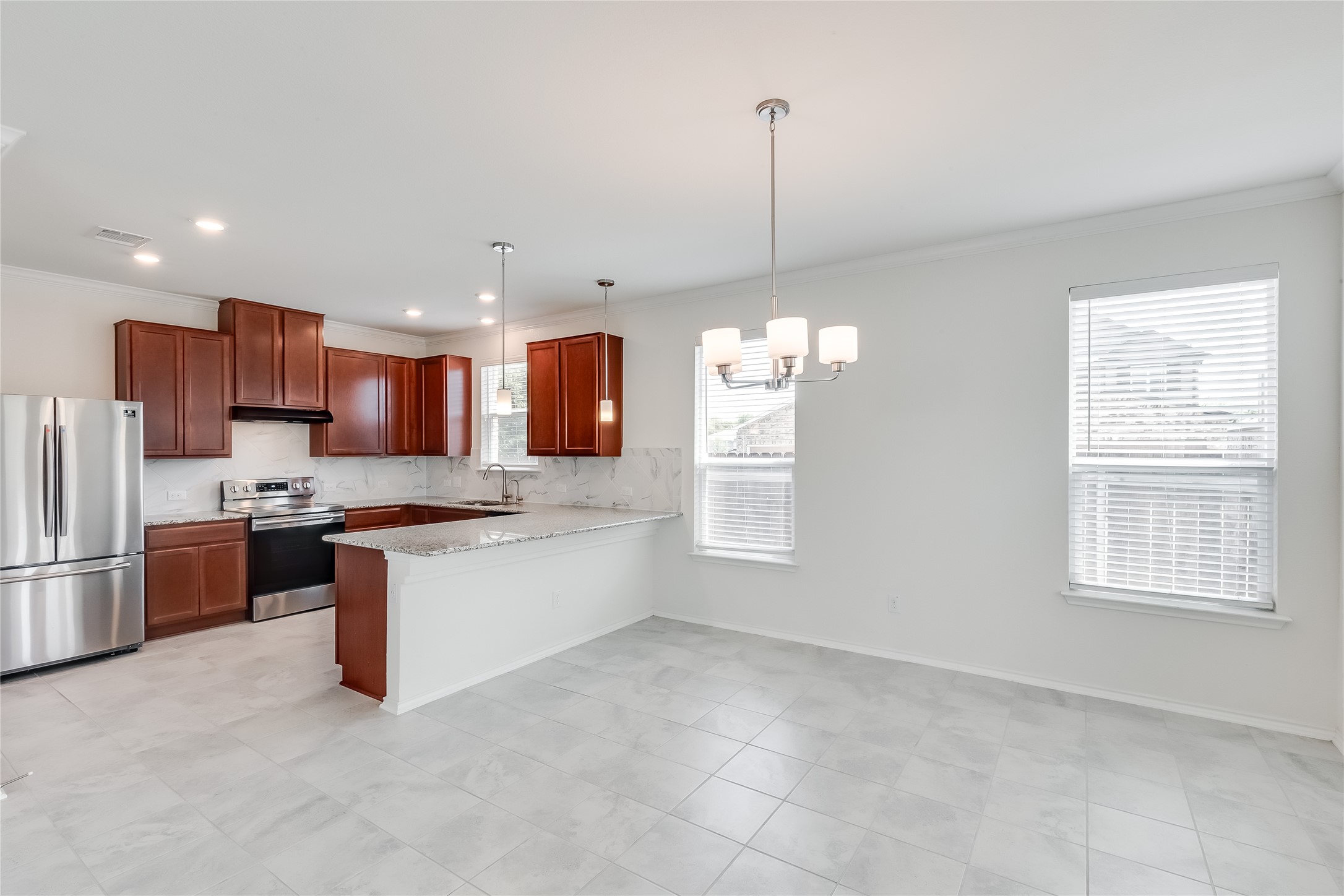 2007 Fretboard Street Round Rock, TX 78664 - Photo 9 of 40 a kitchen with stainless steel appliances kitchen island granite countertop a refrigerator a stove a sink dishwasher and white cabinets with wooden floor