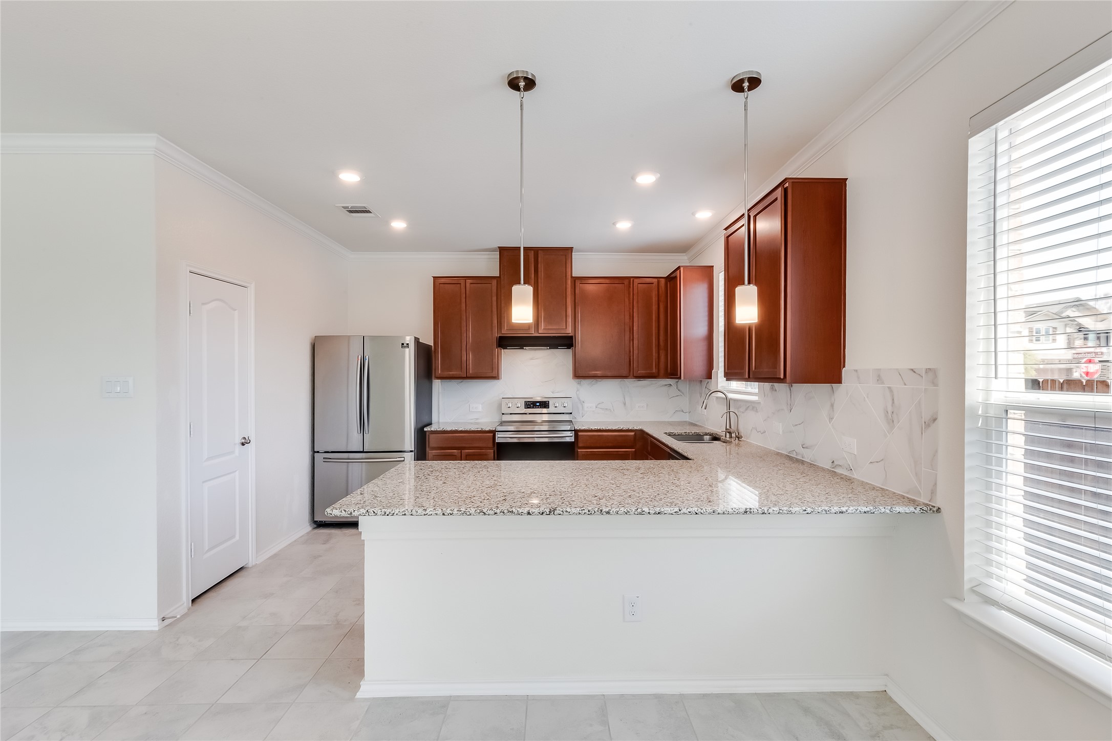2007 Fretboard Street Round Rock, TX 78664 - Photo 10 of 40 a kitchen with stainless steel appliances granite countertop a sink a stove a refrigerator cabinets and a window