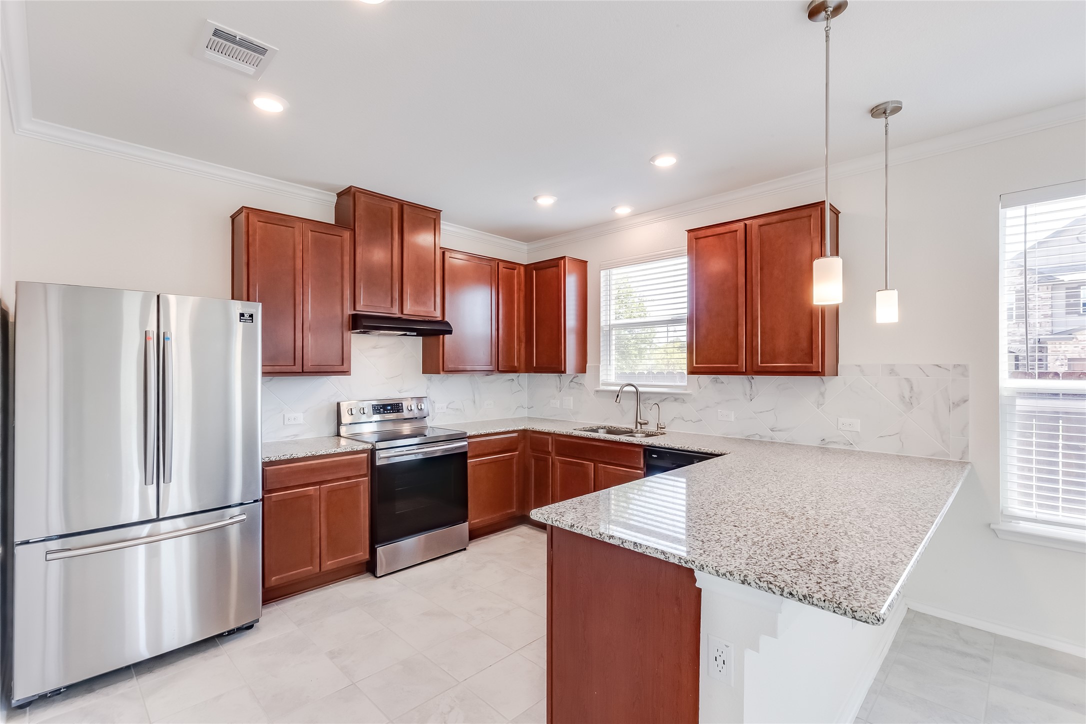 2007 Fretboard Street Round Rock, TX 78664 - Photo 11 of 40 a kitchen with stainless steel appliances granite countertop a sink stove and refrigerator