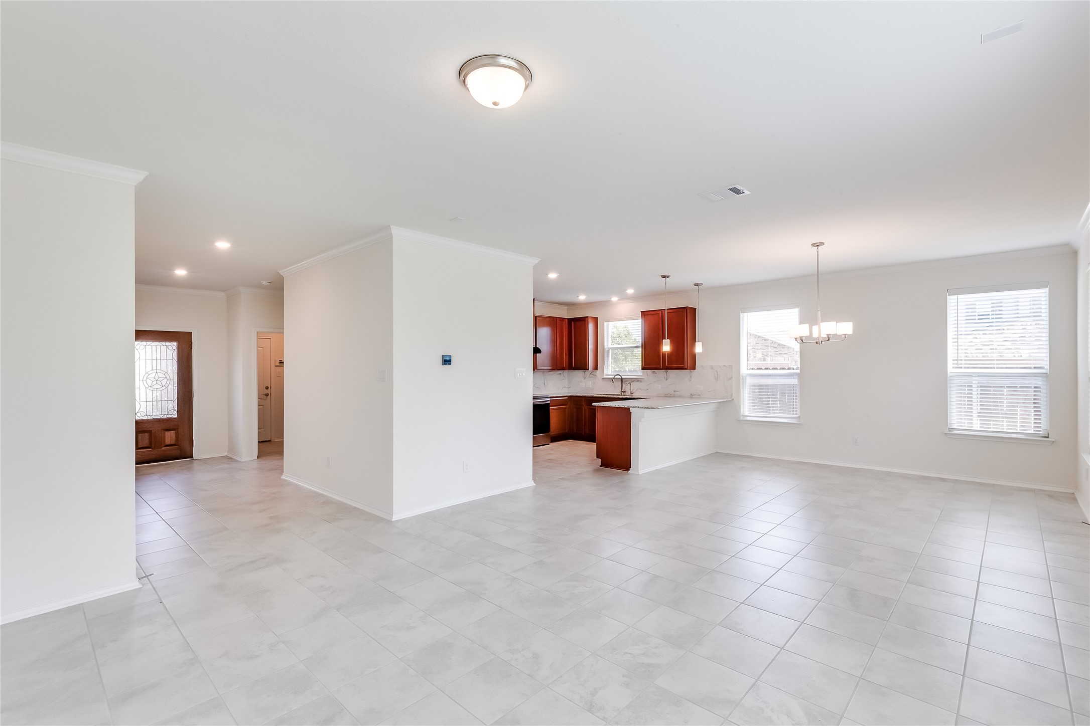 2007 Fretboard Street Round Rock, TX 78664 - Photo 6 of 40 an empty room with a kitchen and windows
