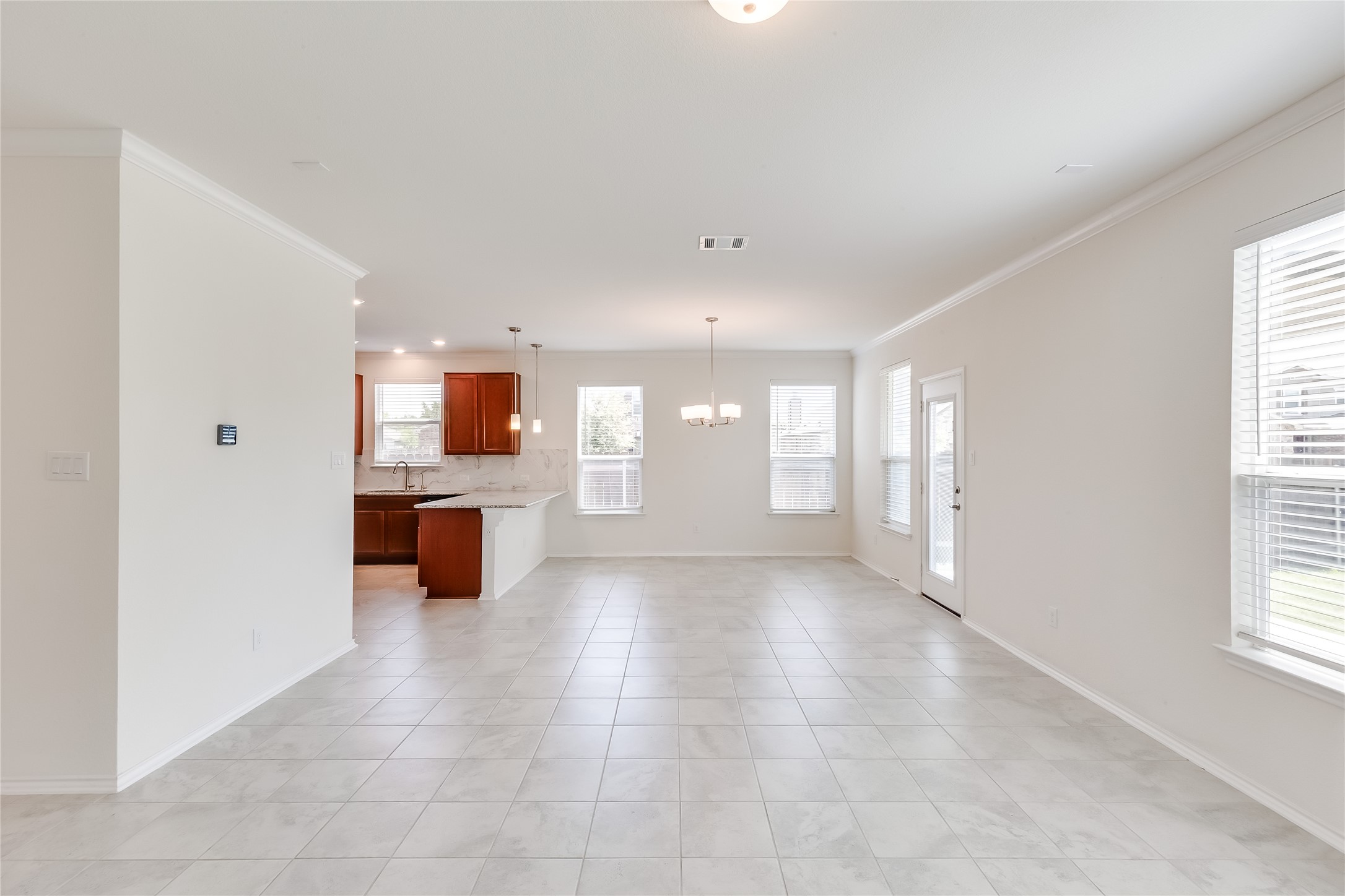 2007 Fretboard Street Round Rock, TX 78664 - Photo 7 of 40 a view of a big room with windows and chandelier fan