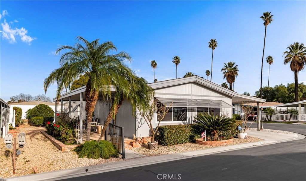 13381 Magnolia, Unit 35 Corona, CA 92879 - Photo 2 of 39 a front view of a house with garden and patio