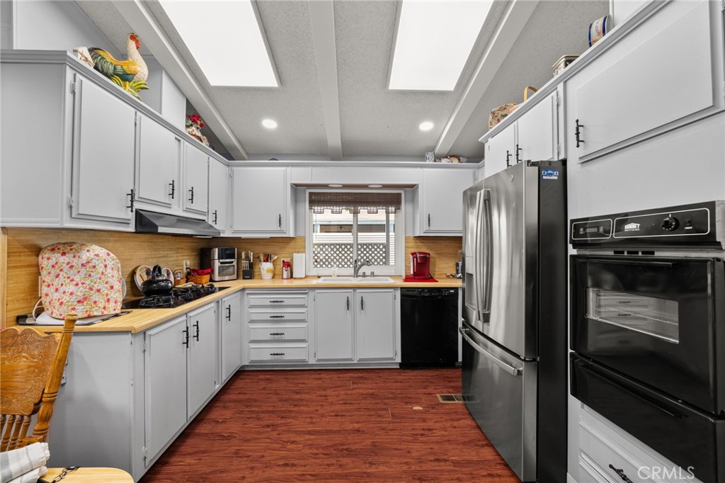 13381 Magnolia, Unit 35 Corona, CA 92879 - Photo 5 of 39 a kitchen with stainless steel appliances granite countertop a refrigerator and a stove top oven