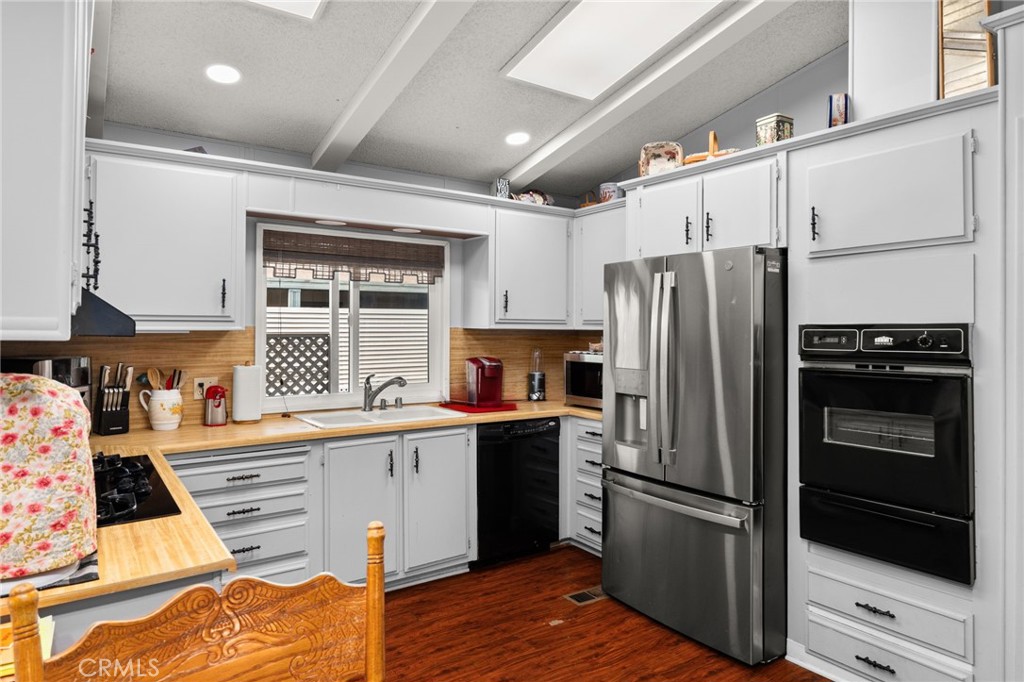 13381 Magnolia, Unit 35 Corona, CA 92879 - Photo 7 of 39 a kitchen with stainless steel appliances a refrigerator and a stove top oven