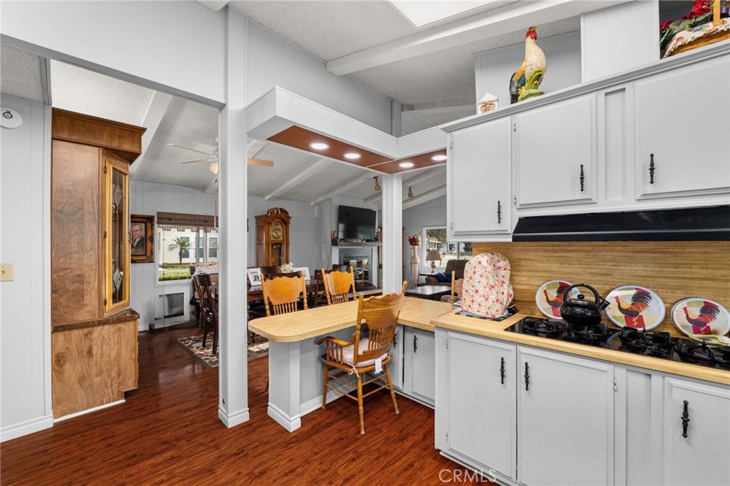 13381 Magnolia, Unit 35 Corona, CA 92879 - Photo 8 of 39 a kitchen with stainless steel appliances granite countertop a refrigerator a stove and white cabinets with wooden floor