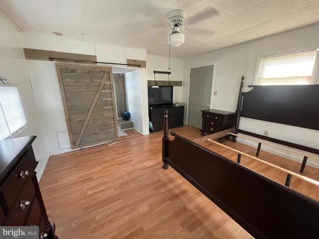 a room with wooden floor and pool table
