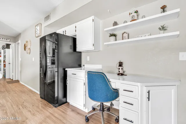 a kitchen with a white cabinets and chandelier