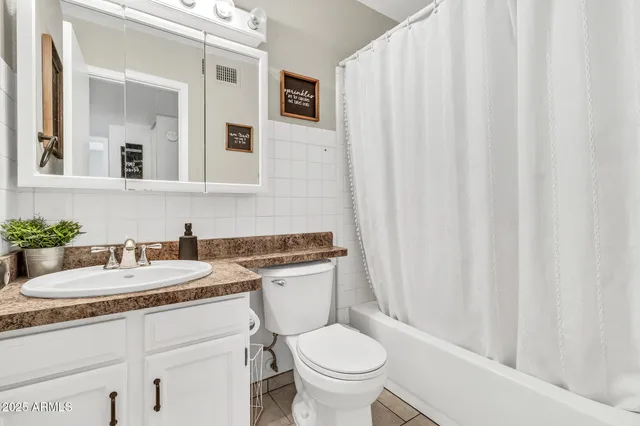 a utility room with cabinets washer and dryer