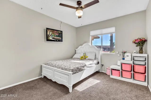 a bedroom with a bed and a painting on the wall