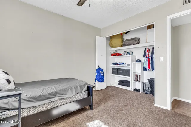 a bedroom with a bed and a table