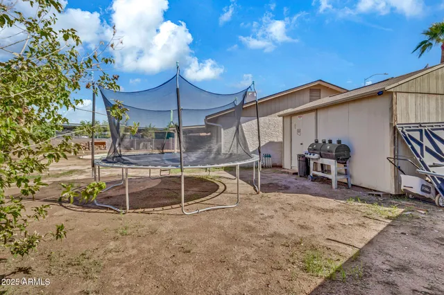 a view of a patio with table and chairs and potted plants