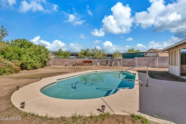 a view of a backyard with a table and chairs