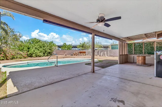 a room with large windows and furniture