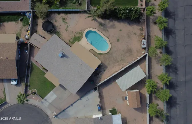 an aerial view of a house with garden space and street view
