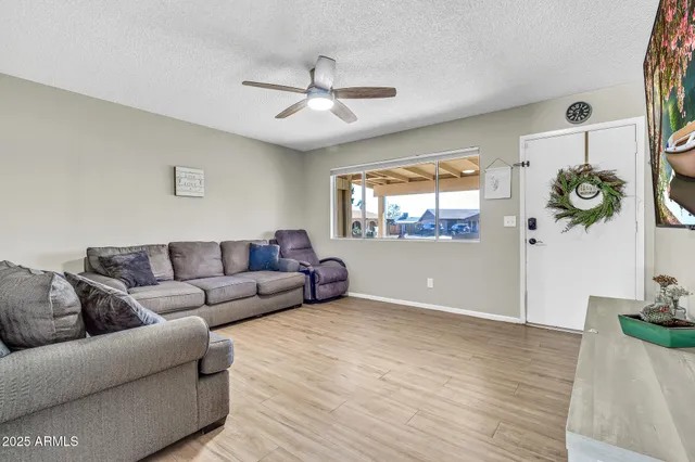 a living room with furniture and a wooden floor