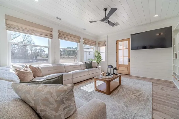 a kitchen with stainless steel appliances a dining table chairs and wooden floor