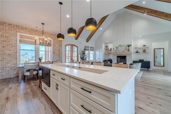 a large kitchen with stainless steel appliances lots of counter space and a sink