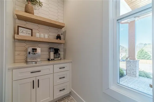 a kitchen with white cabinets and a sink