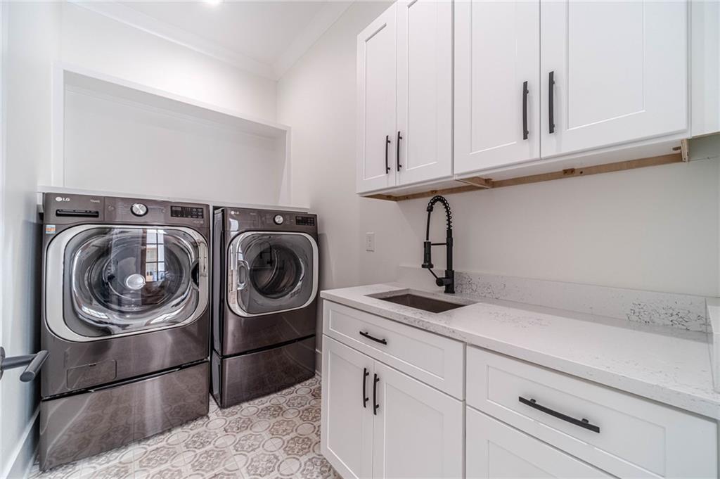 1009 Easy Street Winder, GA 30680 - Photo 20 of 78 a kitchen with white cabinets and a sink