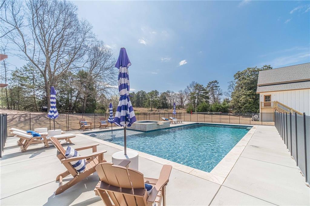 1009 Easy Street Winder, GA 30680 - Photo 2 of 78 a view of a swimming pool with a patio and a yard