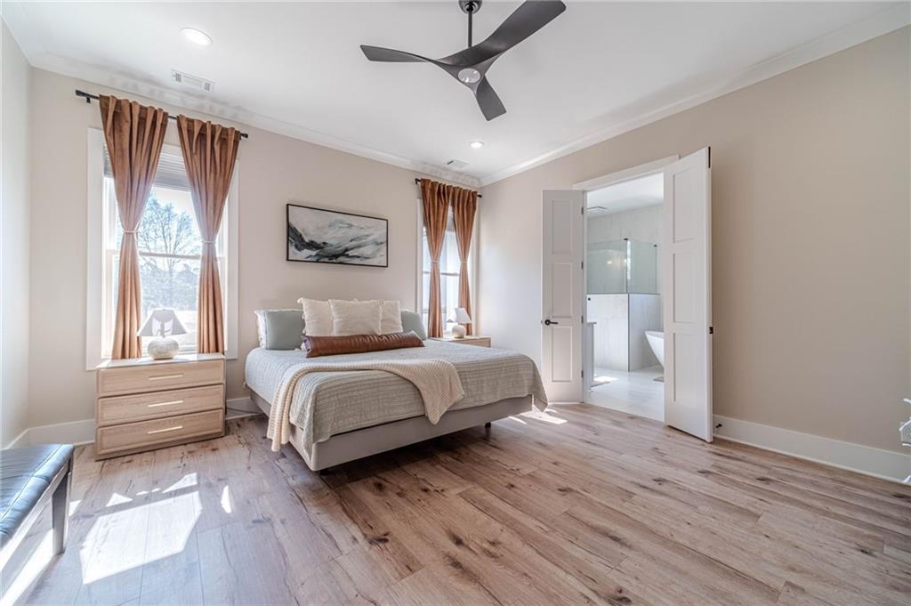 1009 Easy Street Winder, GA 30680 - Photo 22 of 78 a spacious bedroom with a bed and a window