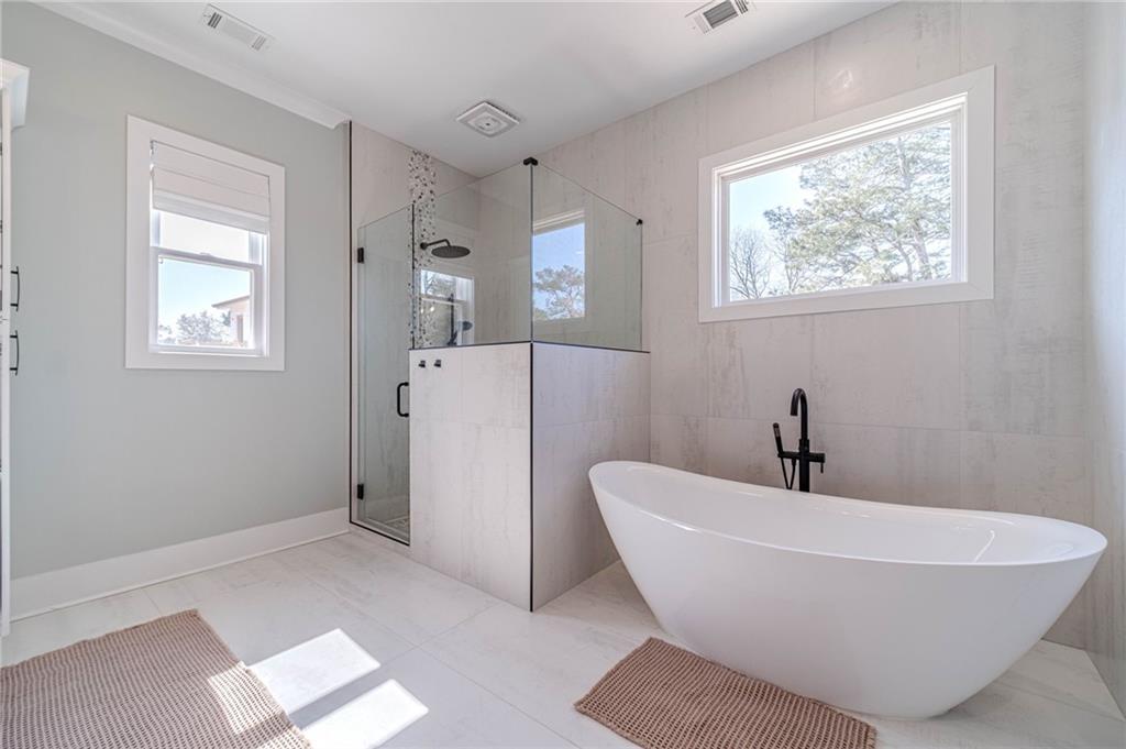 1009 Easy Street Winder, GA 30680 - Photo 25 of 78 a white bath tub sitting in a bathroom