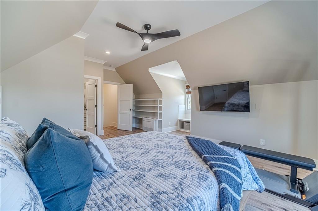 1009 Easy Street Winder, GA 30680 - Photo 28 of 78 a spacious bedroom with a bed and a flat screen tv