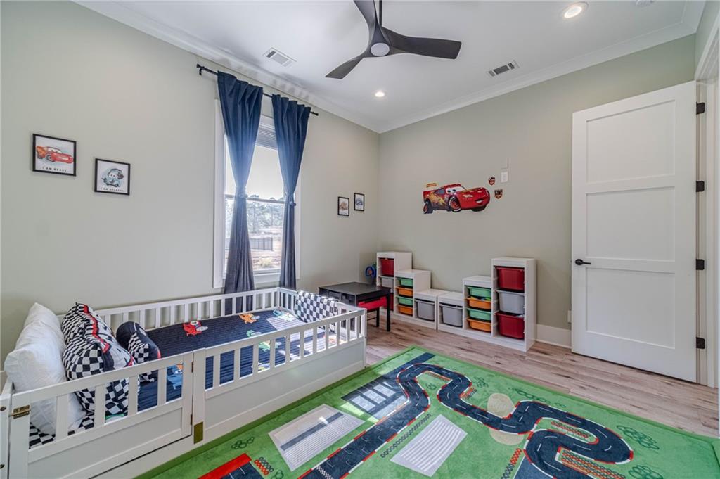 1009 Easy Street Winder, GA 30680 - Photo 34 of 78 a living room with furniture and a baby crib
