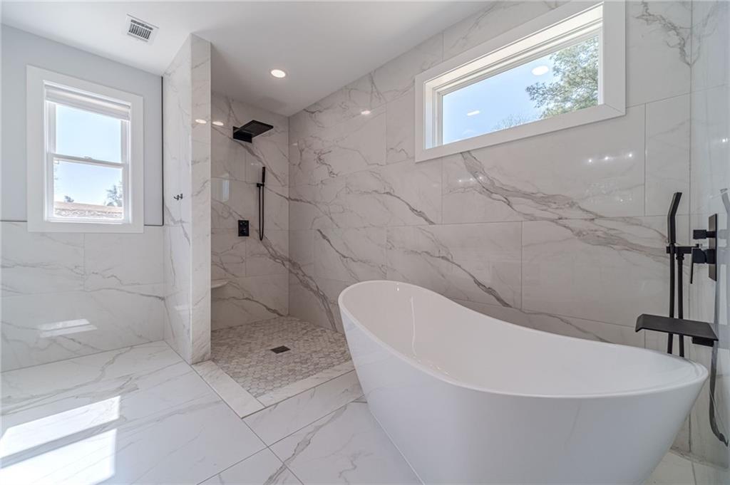1009 Easy Street Winder, GA 30680 - Photo 47 of 78 a white bath tub sitting in a bathroom