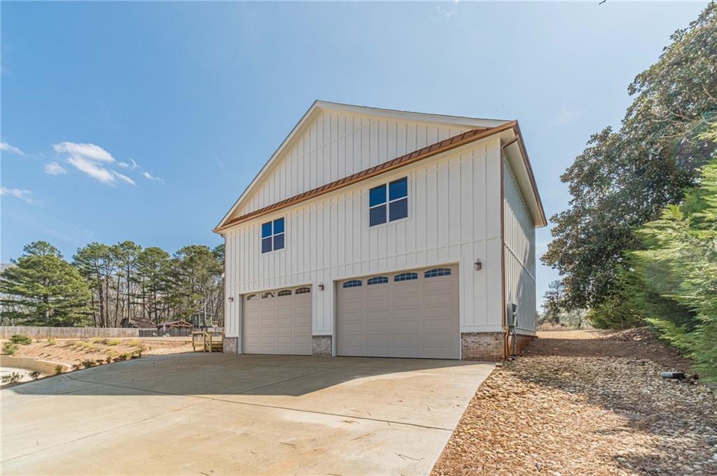 1009 Easy Street Winder, GA 30680 - Photo 62 of 78 a view of a white house with a yard and large tree