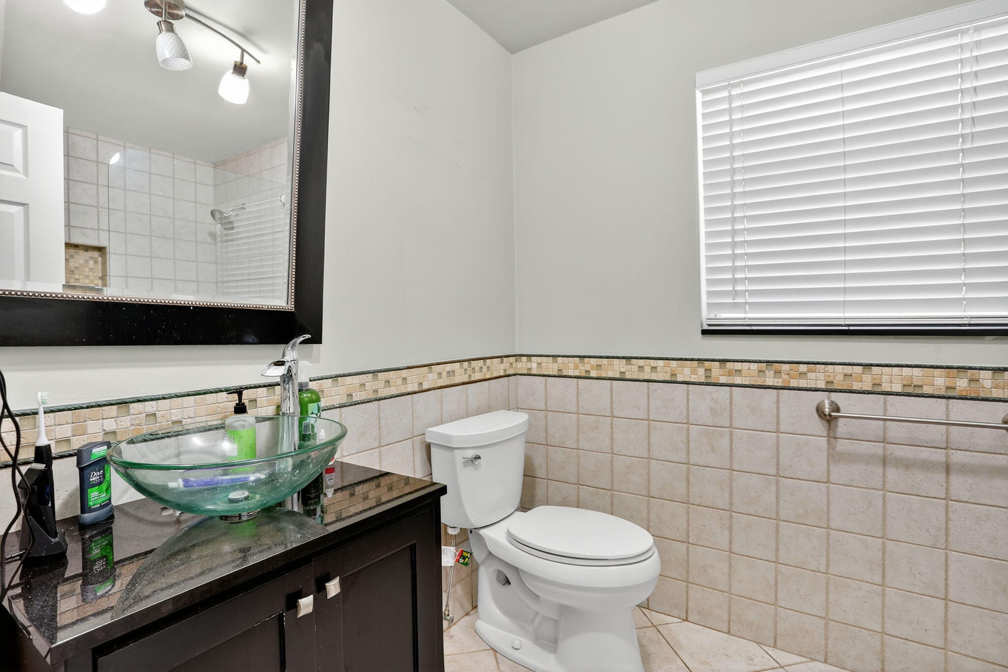 1960 Northeast 31st Street Lighthouse Point, FL 33064 - Photo 16 of 27 a bathroom with a granite countertop sink and a toilet