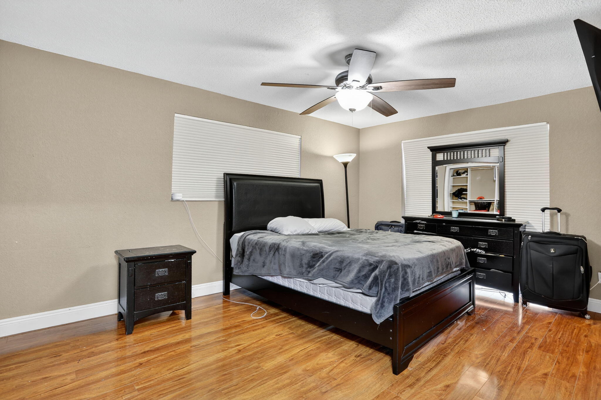 1960 Northeast 31st Street Lighthouse Point, FL 33064 - Photo 18 of 27 a bedroom with a bed and wooden floor