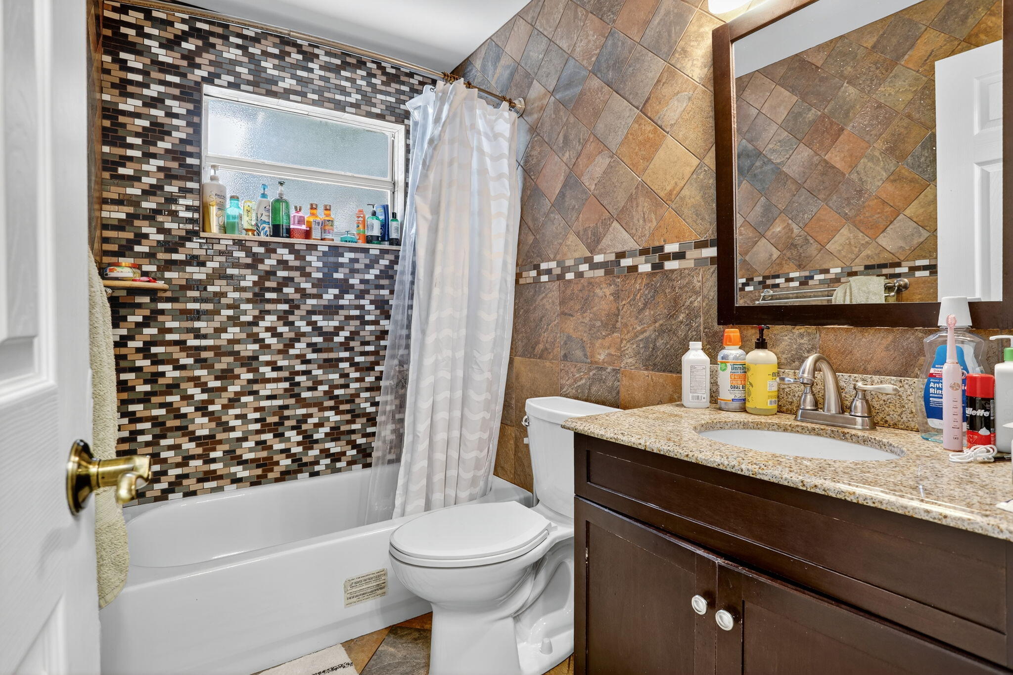 1960 Northeast 31st Street Lighthouse Point, FL 33064 - Photo 20 of 27 a bathroom with a granite countertop sink toilet and shower