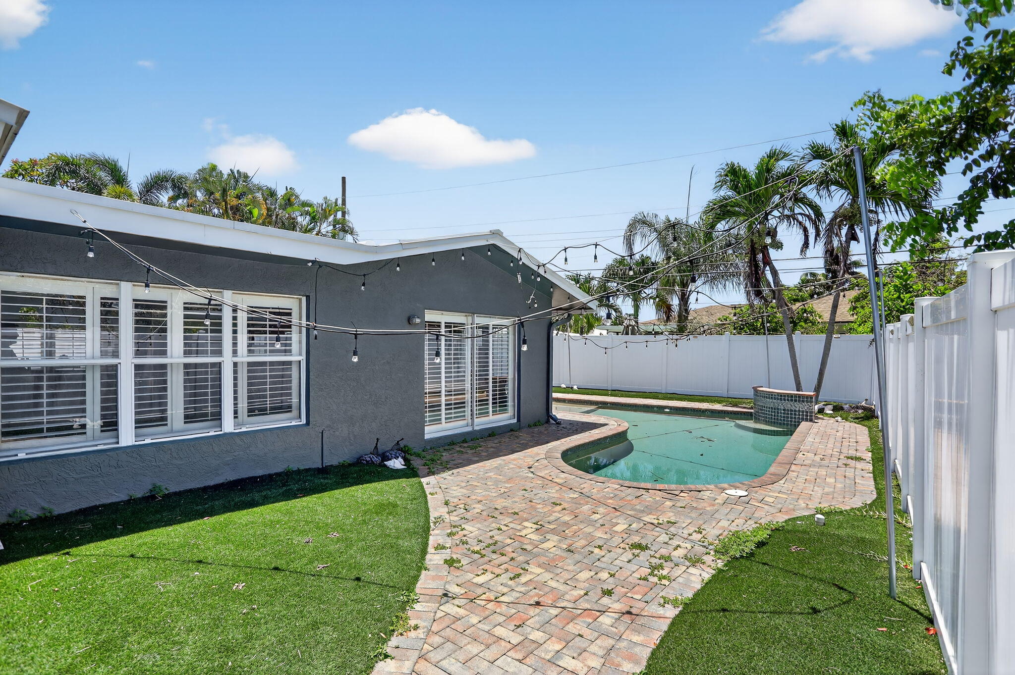 1960 Northeast 31st Street Lighthouse Point, FL 33064 - Photo 22 of 27 a view of a house with a yard and potted plants