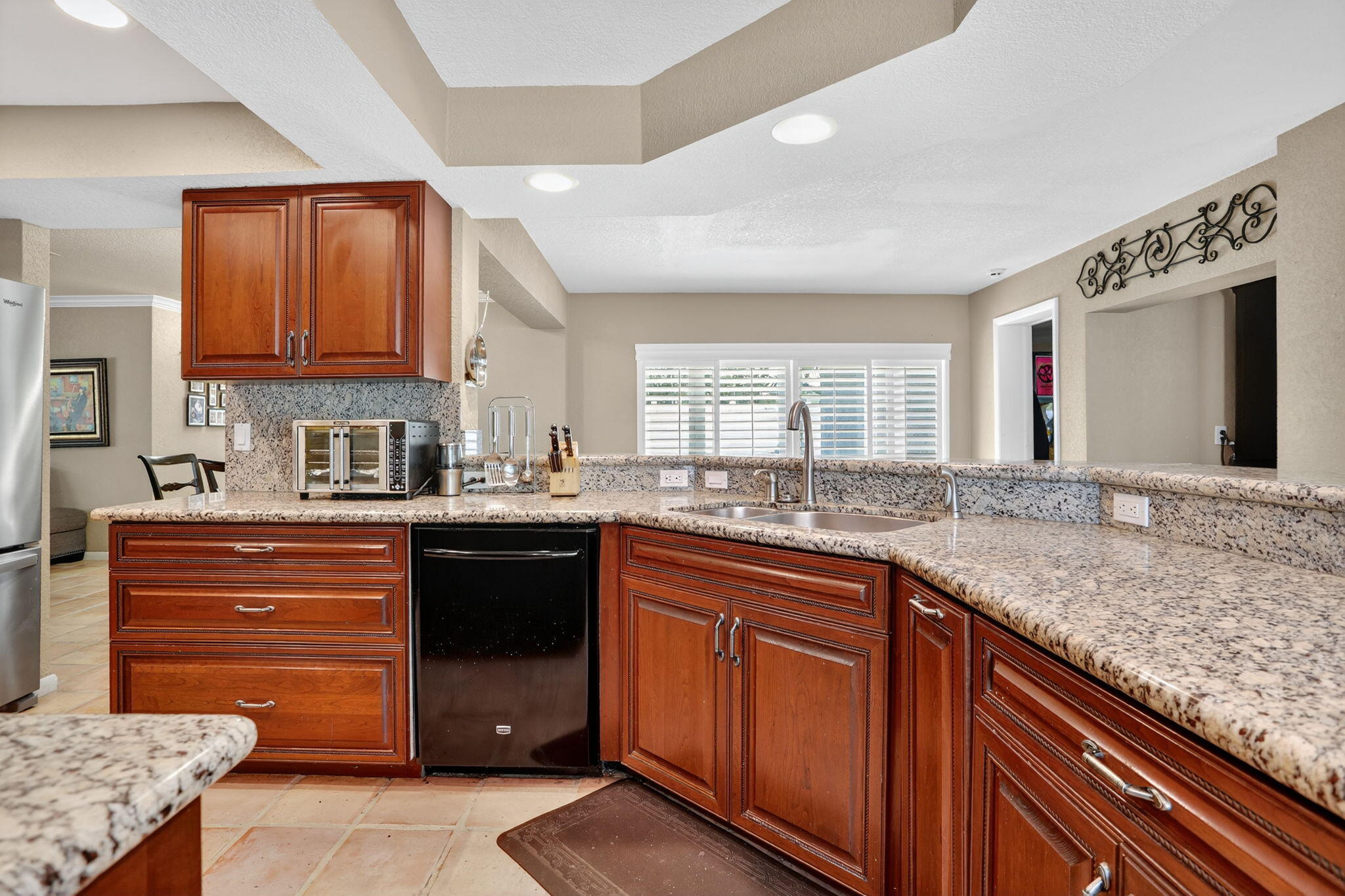 1960 Northeast 31st Street Lighthouse Point, FL 33064 - Photo 5 of 27 a kitchen with stainless steel appliances granite countertop a sink stove and cabinets