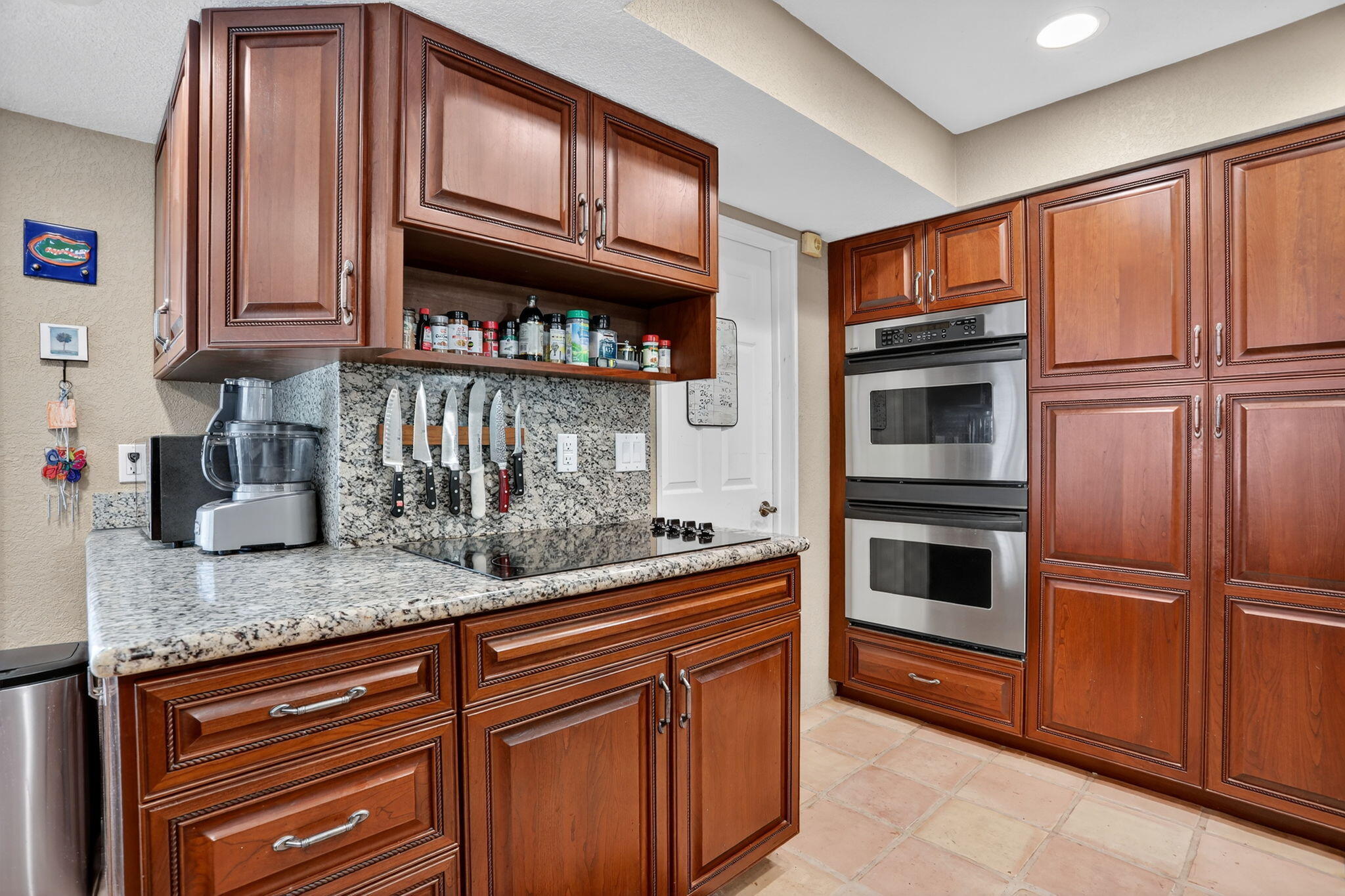 1960 Northeast 31st Street Lighthouse Point, FL 33064 - Photo 6 of 27 a kitchen with granite countertop stainless steel appliances and wooden cabinets