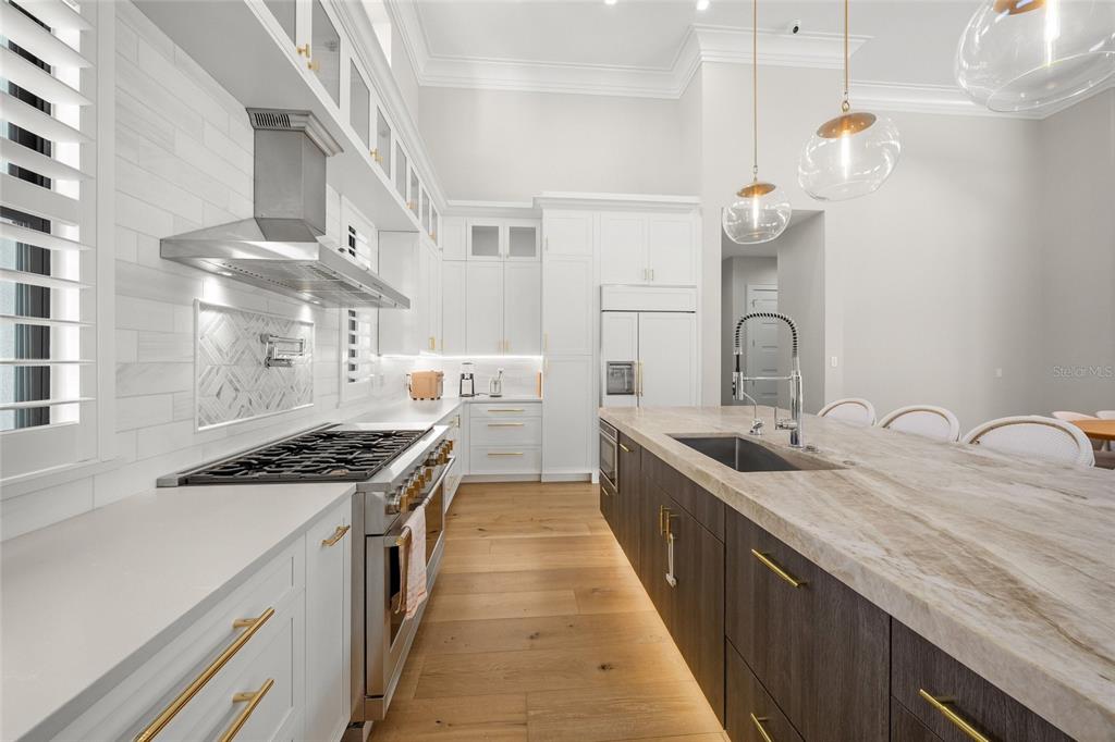 4050 Camino Real Sarasota, FL 34231 - Photo 20 of 59 a kitchen with stainless steel appliances a sink stove and cabinets