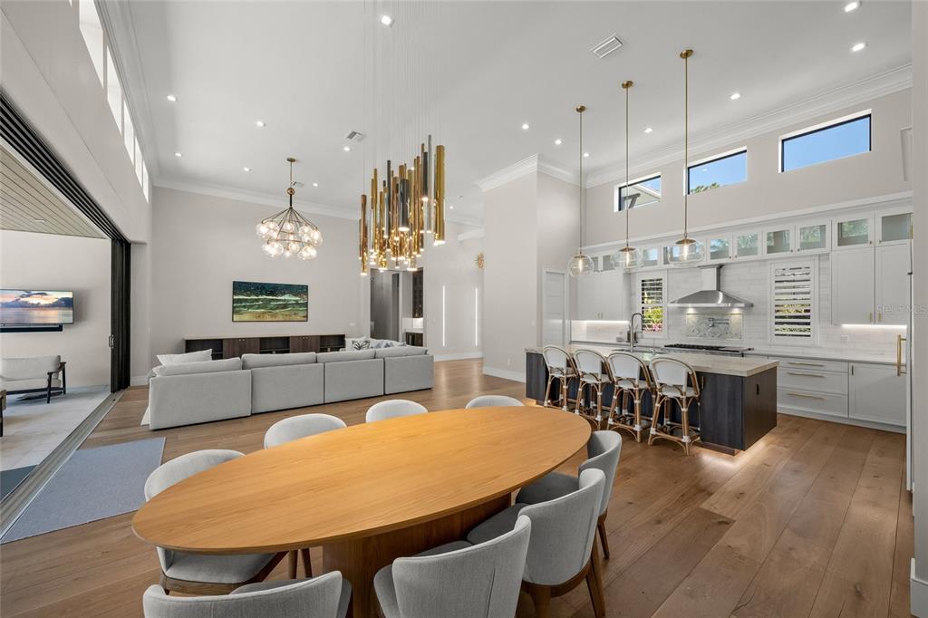 4050 Camino Real Sarasota, FL 34231 - Photo 23 of 59 a large kitchen with a table and chairs