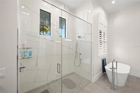 a bathroom with a double vanity sink toilet and shower