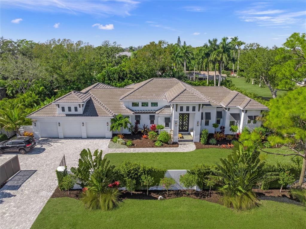 4050 Camino Real Sarasota, FL 34231 - Photo 4 of 59 a aerial view of a house with garden and a sitting area