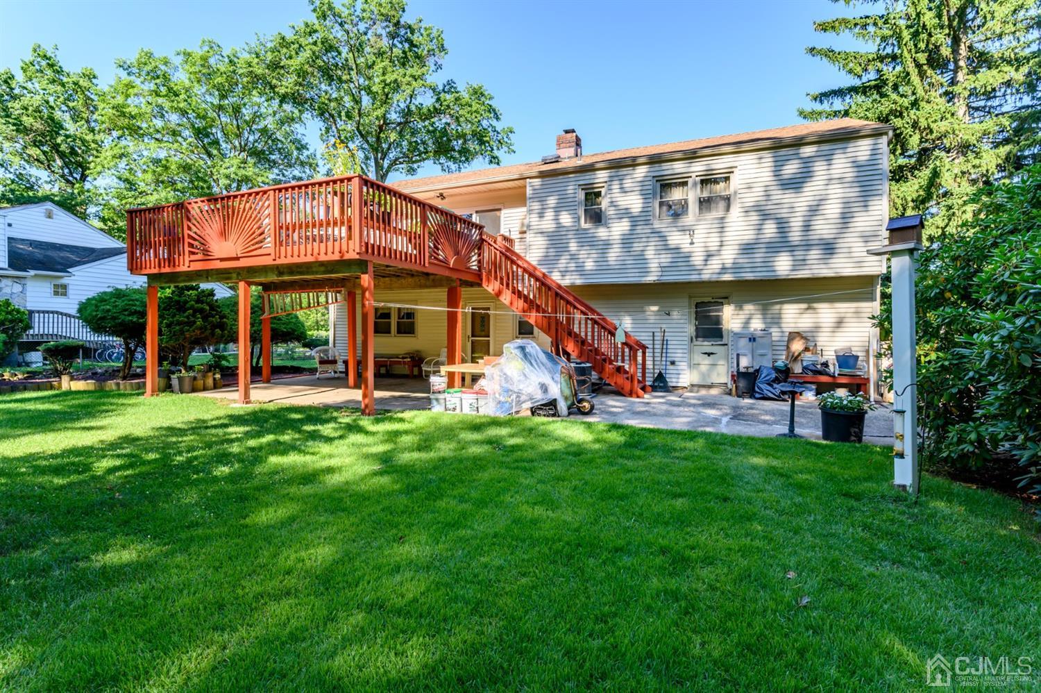 8 Warwick Road Edison, NJ 08820 - Photo 16 of 51 a view of a house with a backyard patio and a slide