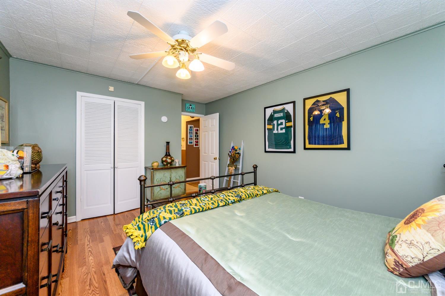 8 Warwick Road Edison, NJ 08820 - Photo 24 of 51 a bedroom with a bed and a chandelier