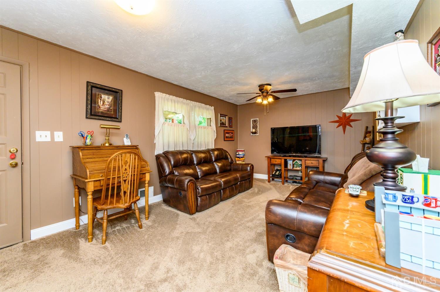 8 Warwick Road Edison, NJ 08820 - Photo 25 of 51 a living room with furniture a flat screen tv and a window