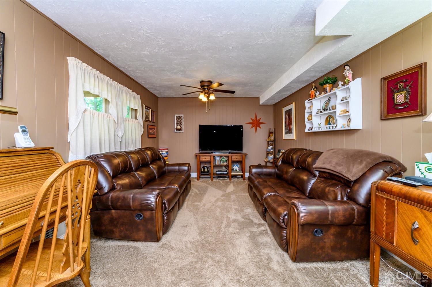8 Warwick Road Edison, NJ 08820 - Photo 26 of 51 a living room with furniture and a flat screen tv