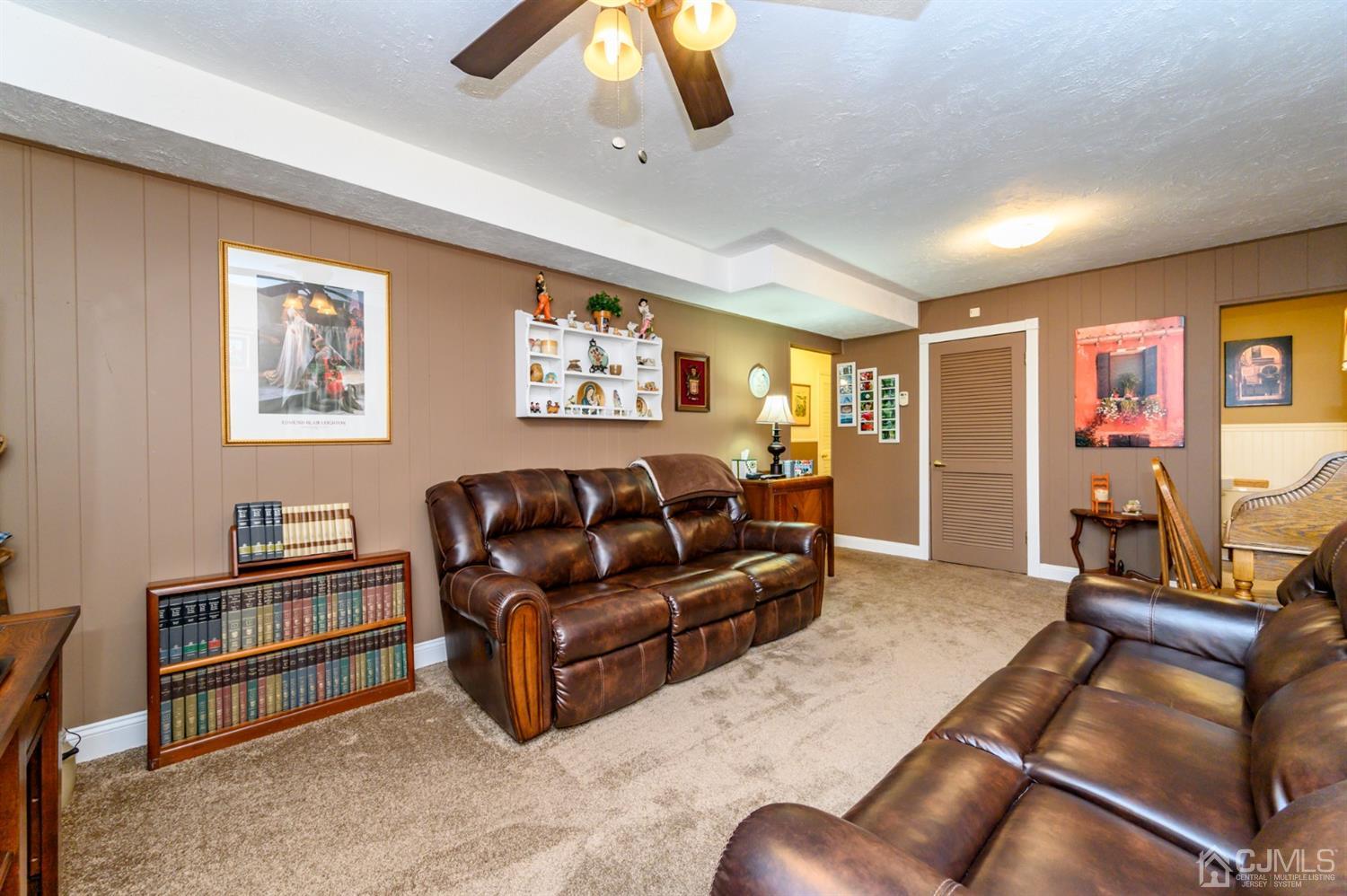 8 Warwick Road Edison, NJ 08820 - Photo 27 of 51 a living room with furniture and a flat screen tv