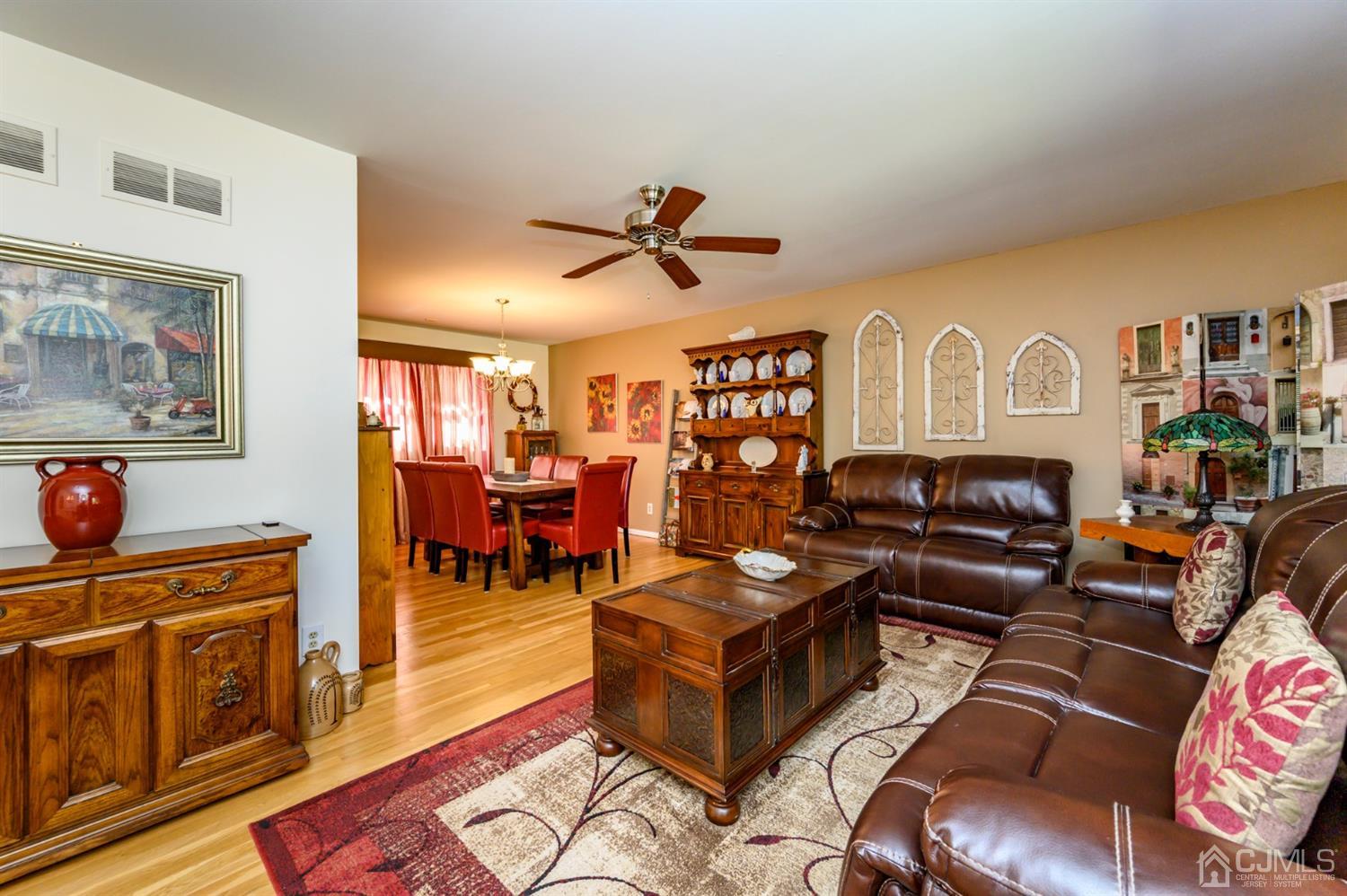 8 Warwick Road Edison, NJ 08820 - Photo 32 of 51 a living room with furniture a flat screen tv and kitchen view