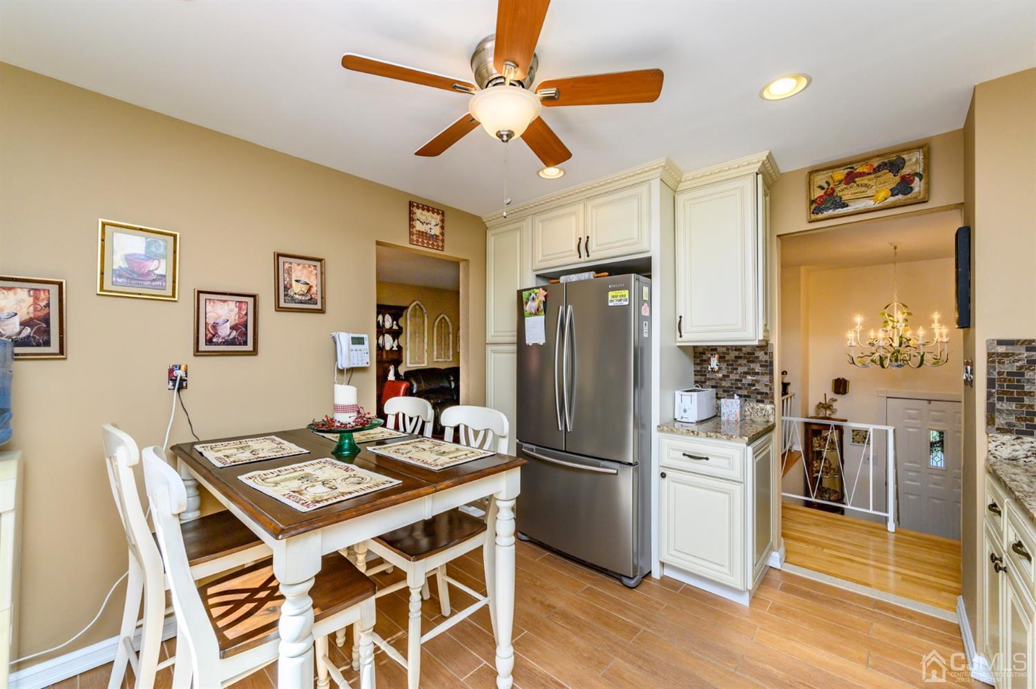 8 Warwick Road Edison, NJ 08820 - Photo 41 of 51 a kitchen with a refrigerator a table and chairs