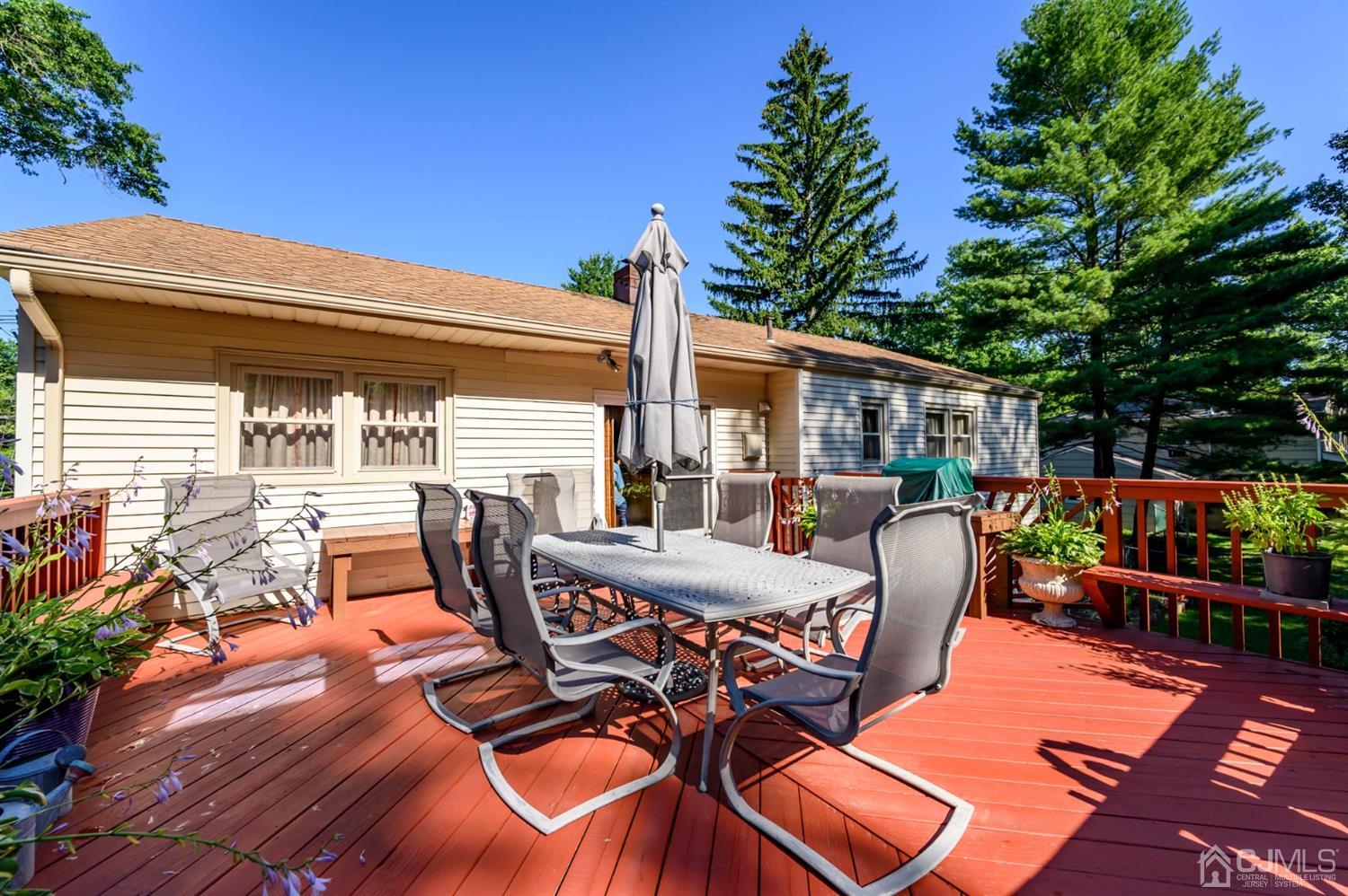 8 Warwick Road Edison, NJ 08820 - Photo 9 of 51 a view of a patio with table and chairs potted plants with wooden floor and fence