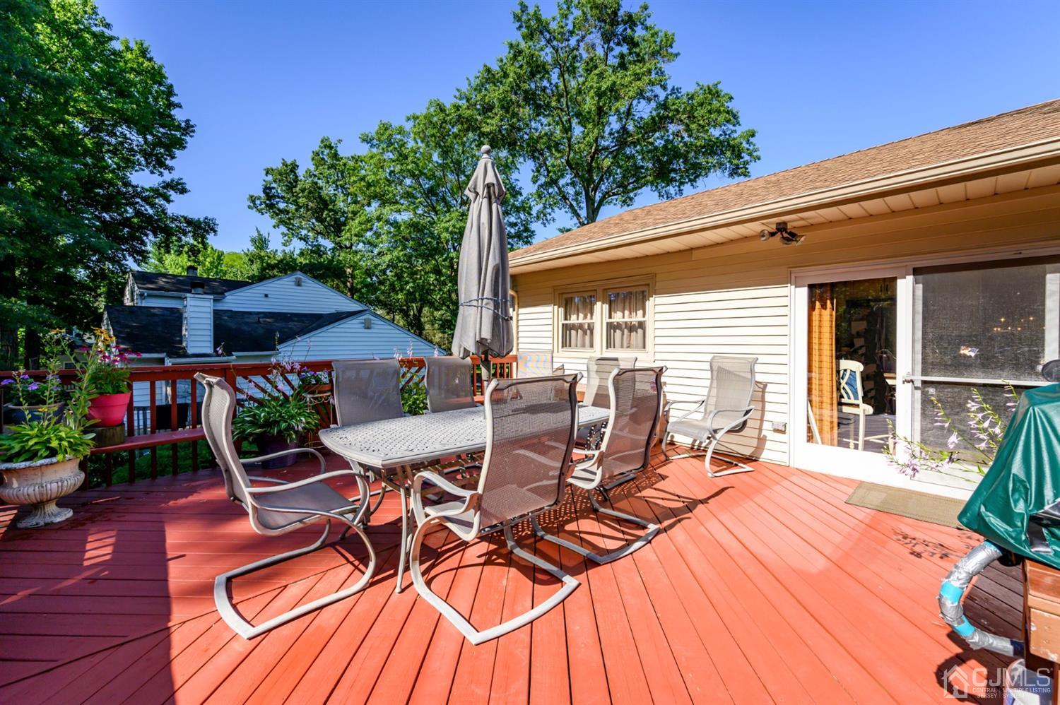 8 Warwick Road Edison, NJ 08820 - Photo 10 of 51 a view of a patio with table and chairs with wooden floor and fence